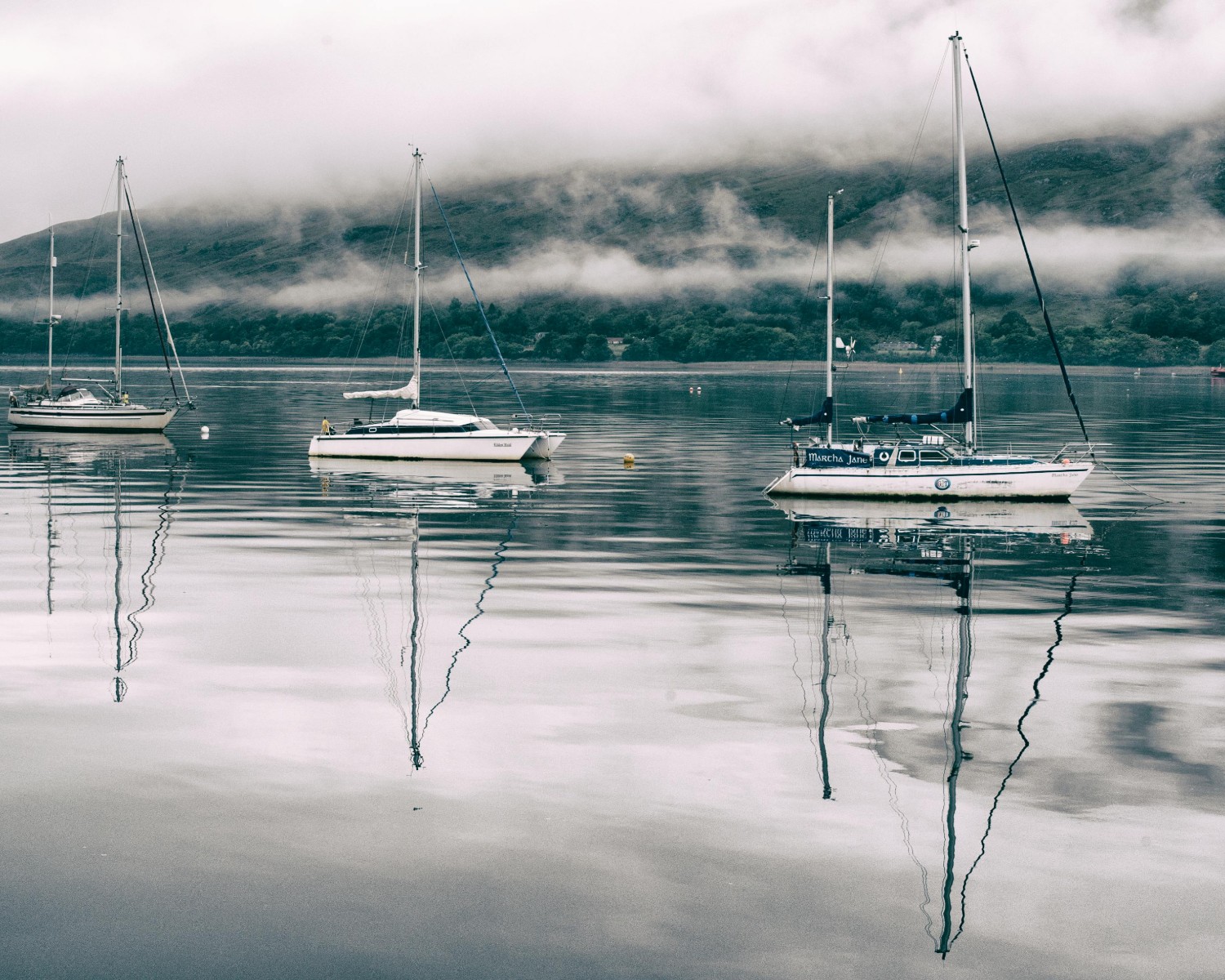 Loch Ness stretching through the Highlands with surrounding mountains