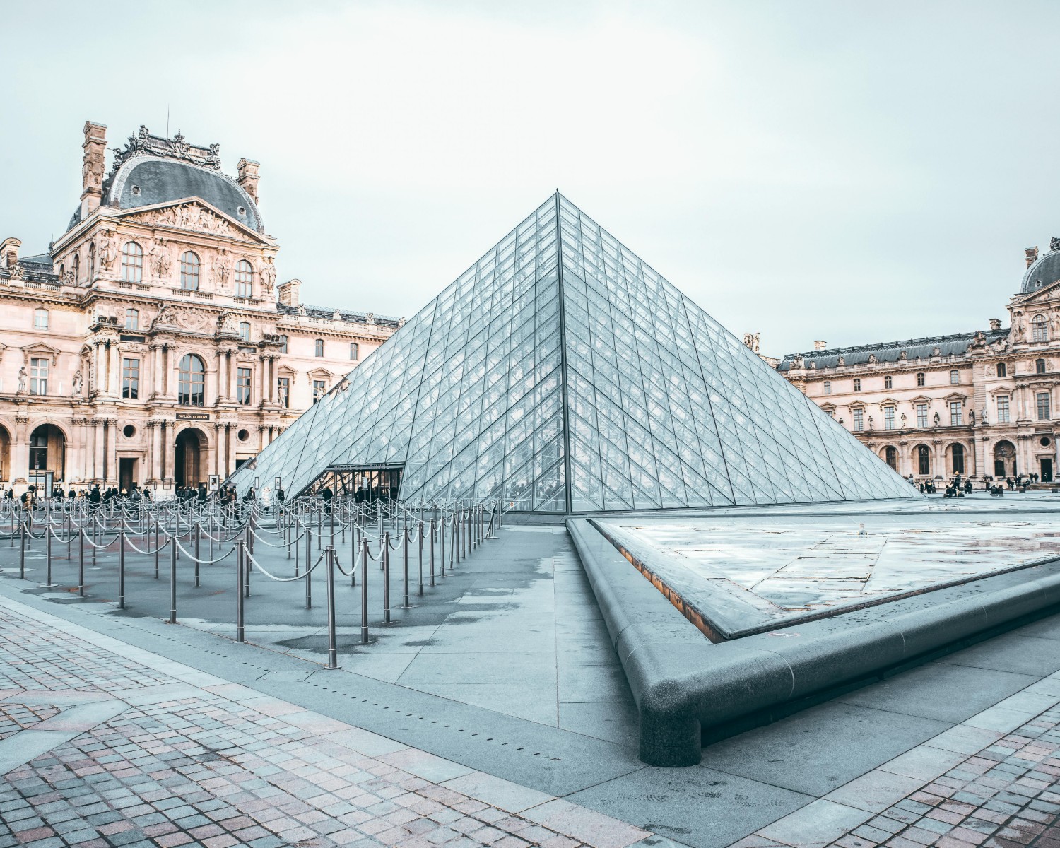 Louvre Palace with glass pyramid—architectural marvel on the Seine